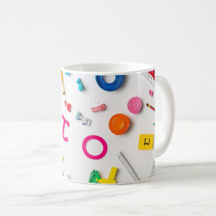 Plastic letters arranged artistically on a dark bl coffee mug