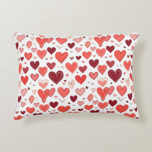 Playful hand drawn red hearts pattern on white decorative cushion