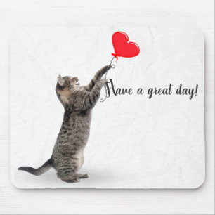 playful tabby cat with heart balloon mouse pad