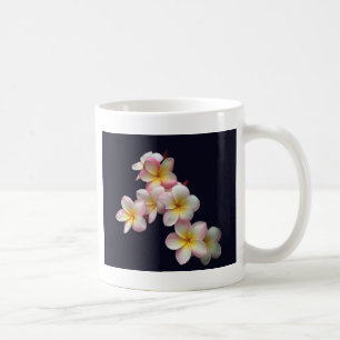 Plumeria blossoms on dark blue coffee mug