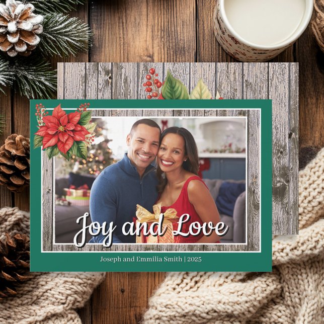 Poinsettia Rustic Wood Green Family Photo  Holiday Card (Emerald green photo "Love and Joy" Christmas greeting card with poinsettia in the corner. )