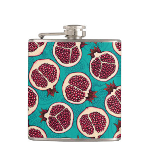 Pomegranate slices on turquoise hip flask