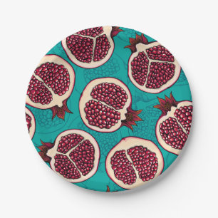 Pomegranate slices on turquoise paper plate