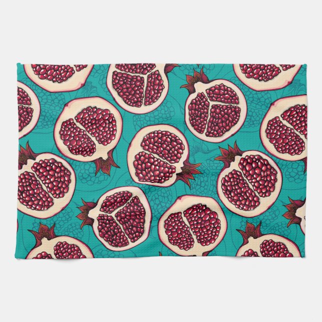 Pomegranate slices on turquoise tea towel (Horizontal)