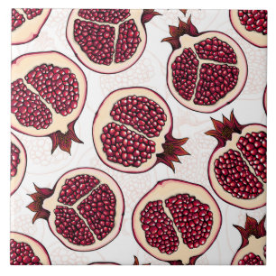 Pomegranate slices on white ceramic tile