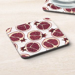 Pomegranate slices on white coaster