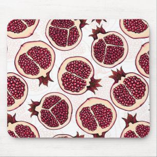 Pomegranate slices on white mouse pad
