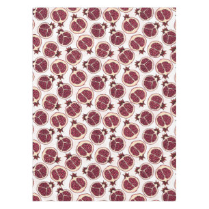 Pomegranate slices on white tablecloth