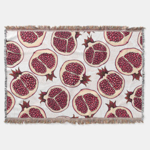 Pomegranate slices on white throw blanket