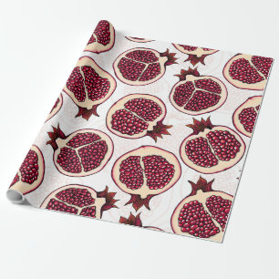 Pomegranate slices on white wrapping paper