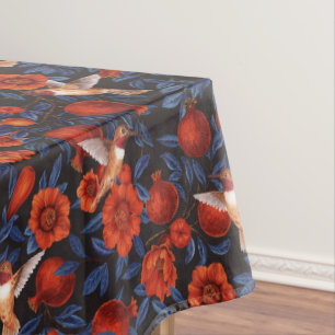 Pomegranates and hummingbirds/blue leaves on black tablecloth