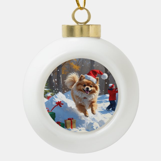 Pomeranian Running in Snow with Christmas Hat Ceramic Ball Christmas Ornament (Front)