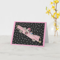 Poodle at Christmas in a pink convertible