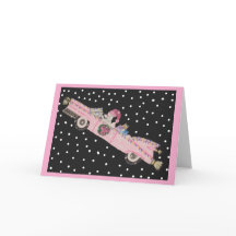 Poodle at Christmas in a pink convertible