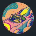 Pop Art Astronaut Driving Rocket Car Large Clock<br><div class="desc">This is a vibrant digital illustration in a pop art style featuring an astronaut driving a futuristic, rocket-powered car. The astronaut, wearing a yellow and white spacesuit with a green visor, is at the wheel of a pink and yellow car with large rocket boosters attached to the rear. Flames and...</div>