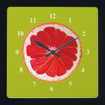 Pop art pink grapefruit art original watercolour square wall clock<br><div class="desc">A cute and colourful vibrant pink grapefruit slice from an original painting by artist Sacha Grossel. This large pop art style fruit is pink and very bright and colourful against a customisable lime green coloured background. Quirky and original.</div>