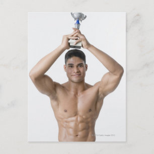 Portrait of a young man holding a trophy postcard
