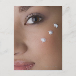 Portrait of a young woman with cream on her postcard