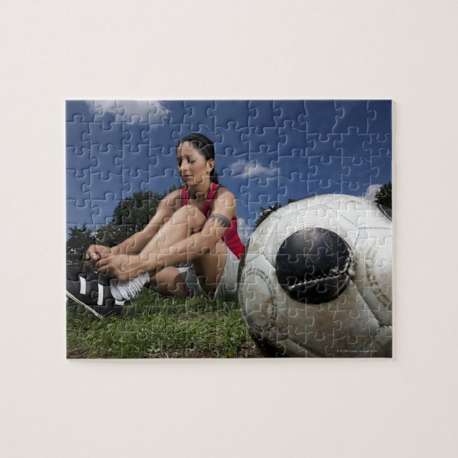 portrait of female football player tying her jigsaw puzzle (Horizontal)