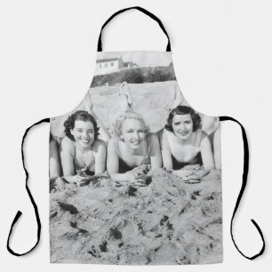Portrait of five young women lying on the beach an apron