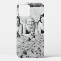 Portrait of five young women lying on the beach an