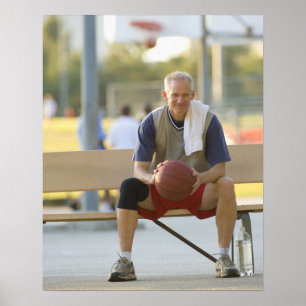 Portrait of mature man with basketball sitting poster
