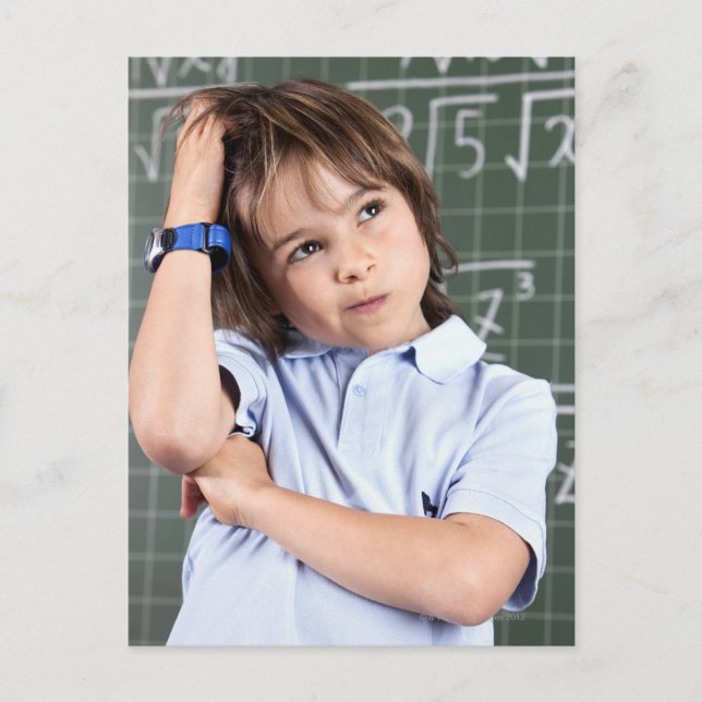 portrait of young boy in classroom in front pof postcard (Front)
