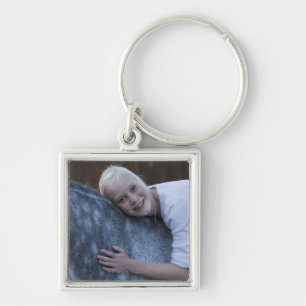 portrait of young girl on white horse key ring