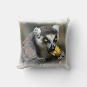 Portrait ring-tailed lemur eating a banana cushion