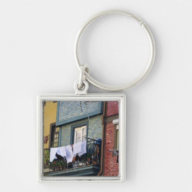 Portugal, Oporto (Porto). Woman hanging laundry Key Ring (Front)