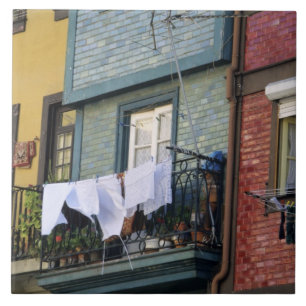 Portugal, Oporto (Porto). Woman hanging laundry Tile