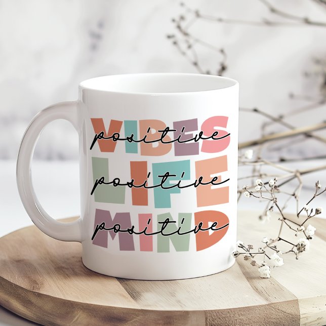 Positive Mind Aesthetic Typography Mug (Positive Vibes Positive Life Inspirational Coffee Mug on a boho kitchen table with tiny white flower)