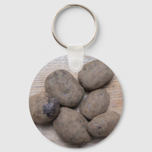 Potatoes on rustic wood Concept Key Ring