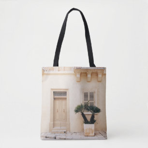 Potter plant near concrete house tote bag