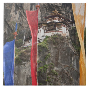 Prayer flags hang near Taktshang Tile