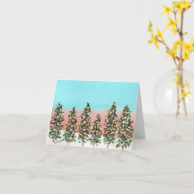 Pre-dawn row of colourful Christmas trees
