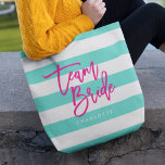 Preppy Turquoise and White Stripes Pink Team Bride Tote Bag<br><div class="desc">All-Over-Print Tote bag featuring the words "Team Bride" in pink trendy script against a turquoise and white stripes pattern background. Perfect for weddings for bridesmaids, maid of honour and flower girl. For other colours and matching items see here https://www.zazzle.com/collections/119250194970828530?rf=238364477188679314 Personalise it by replacing the placeholder text. For more options such...</div>