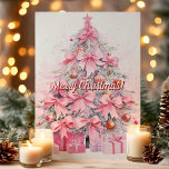 Pretty Pink Bow Christmas Tree Merry Christmas Holiday Card<br><div class="desc">Send festive greetings with this charming card featuring a pink Christmas tree adorned with elegant bows and beautifully wrapped presents. The "Merry Christmas!" message adds a joyful touch to this lovely design,  perfect for spreading holiday cheer to friends and family.</div>