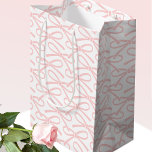 Pretty Pink Bow Pattern White Medium Gift Bag<br><div class="desc">A simple and stylish gift bag, with a pretty ribbon bow pattern in a colour palette of blush pink and white. A perfect addition to your gift wrap for all types of celebration, including birthdays, baby showers, Mother's Day, weddings and more! Blush pink and white colour palette, available with a...</div>