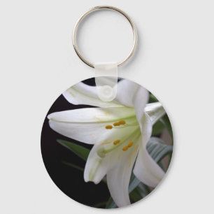 Pretty, pure white Easter lily flower in black Key Ring