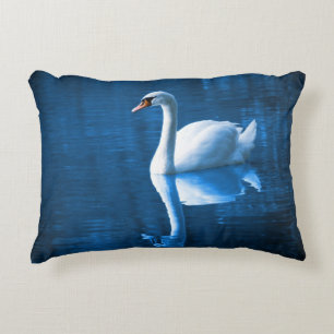 Pretty white swan floating on a blue lake decorative cushion