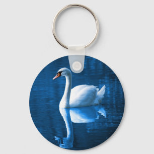 Pretty white swan floating on a blue lake key ring