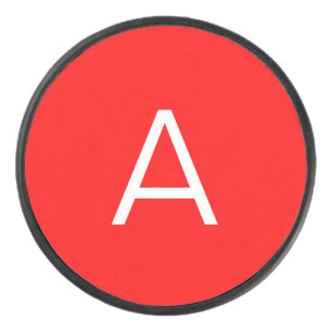 Professional red monogram initial letter hockey puck