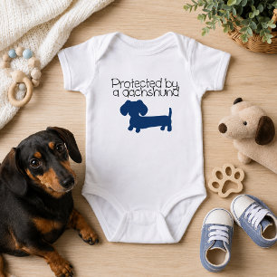 Protected by a Dachshund (blue) Baby Bodysuit