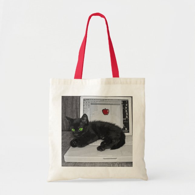 Prunella black cat lounging on laptop tote bag (Front)