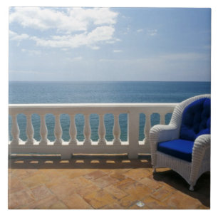 Puerto Rico. Wicker chair and tiled terrace at Tile