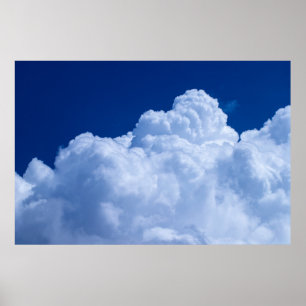Puffy clouds in blue sky poster