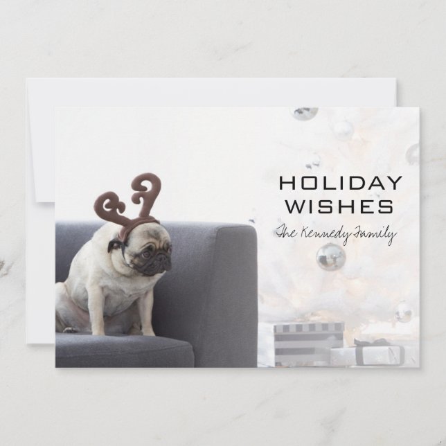 Pug dog wearing reindeer horns on couch holiday card (Front)