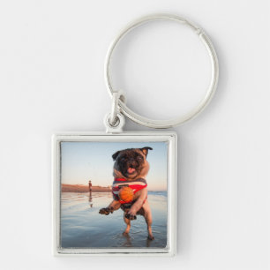 Pug Playing Ball on Beach Key Ring