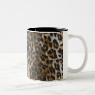 Pug puppy sitting against animal print Two-Tone coffee mug